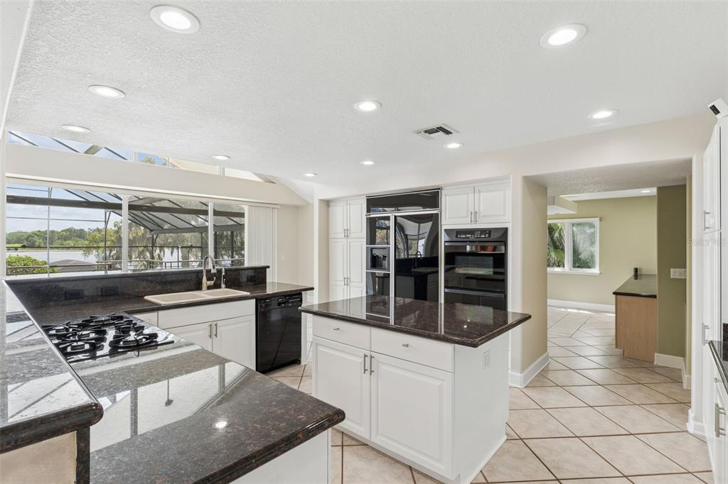 4301 Down Point Lane Windermere, FL 34786 - Photo 21 of 61 a kitchen with stainless steel appliances kitchen island granite countertop a stove and cabinets