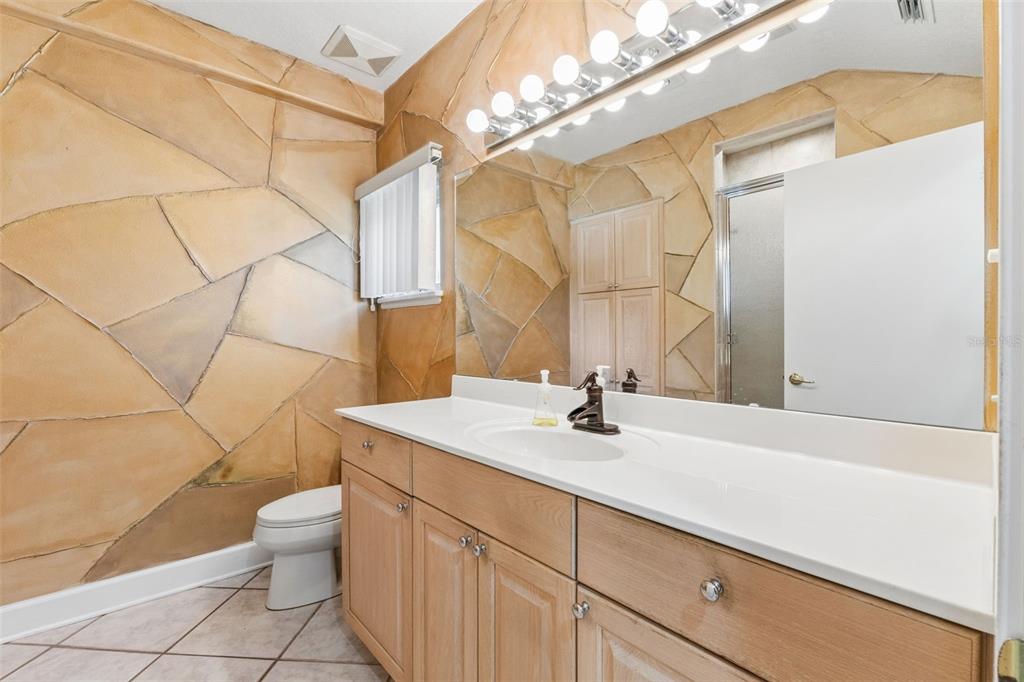 4301 Down Point Lane Windermere, FL 34786 - Photo 31 of 61 a bathroom with a sink a toilet and mirror