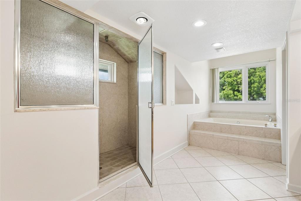 4301 Down Point Lane Windermere, FL 34786 - Photo 38 of 61 a bathroom with a bathtub and a shower