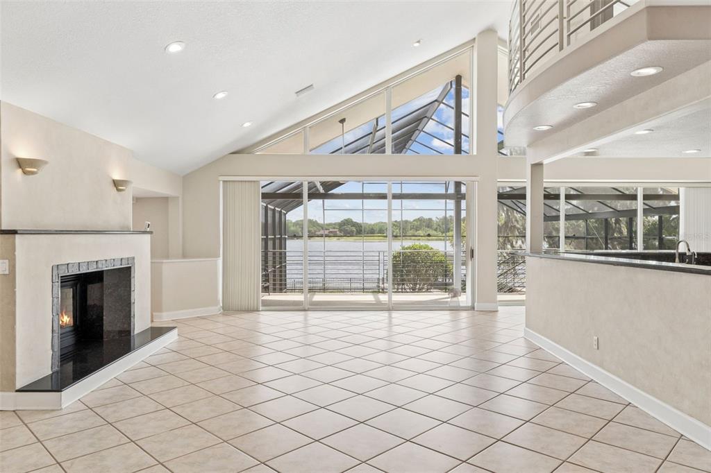 4301 Down Point Lane Windermere, FL 34786 - Photo 4 of 61 a view of an empty room with a fireplace and a large window
