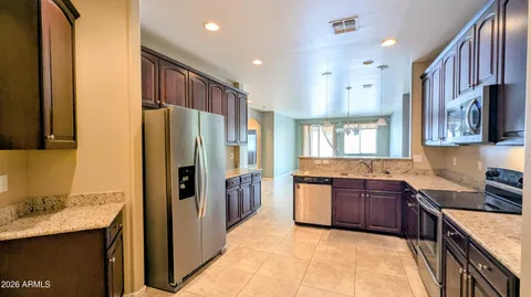 a kitchen with granite countertop stainless steel appliances and wooden cabinets