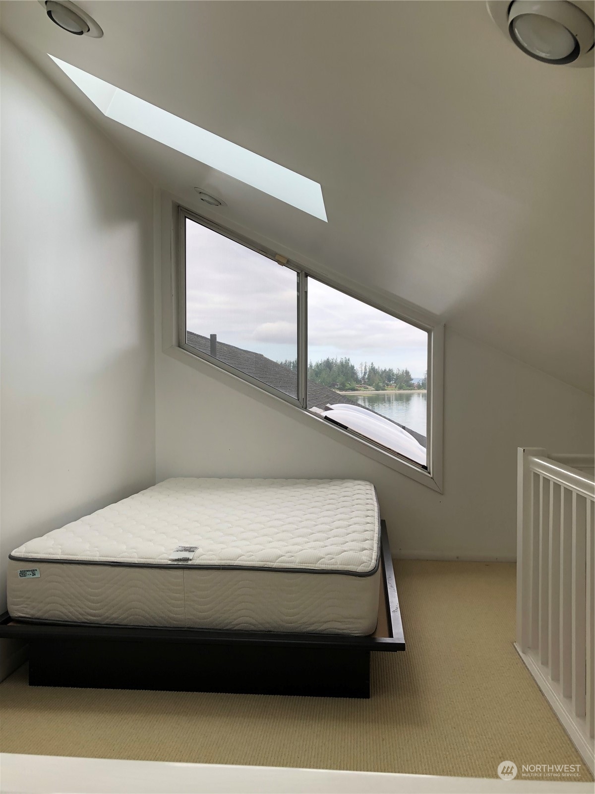 6918 Totem Beach Loop Road Marysville, WA 98271 - Photo 26 of 29 a room with wooden floor and window