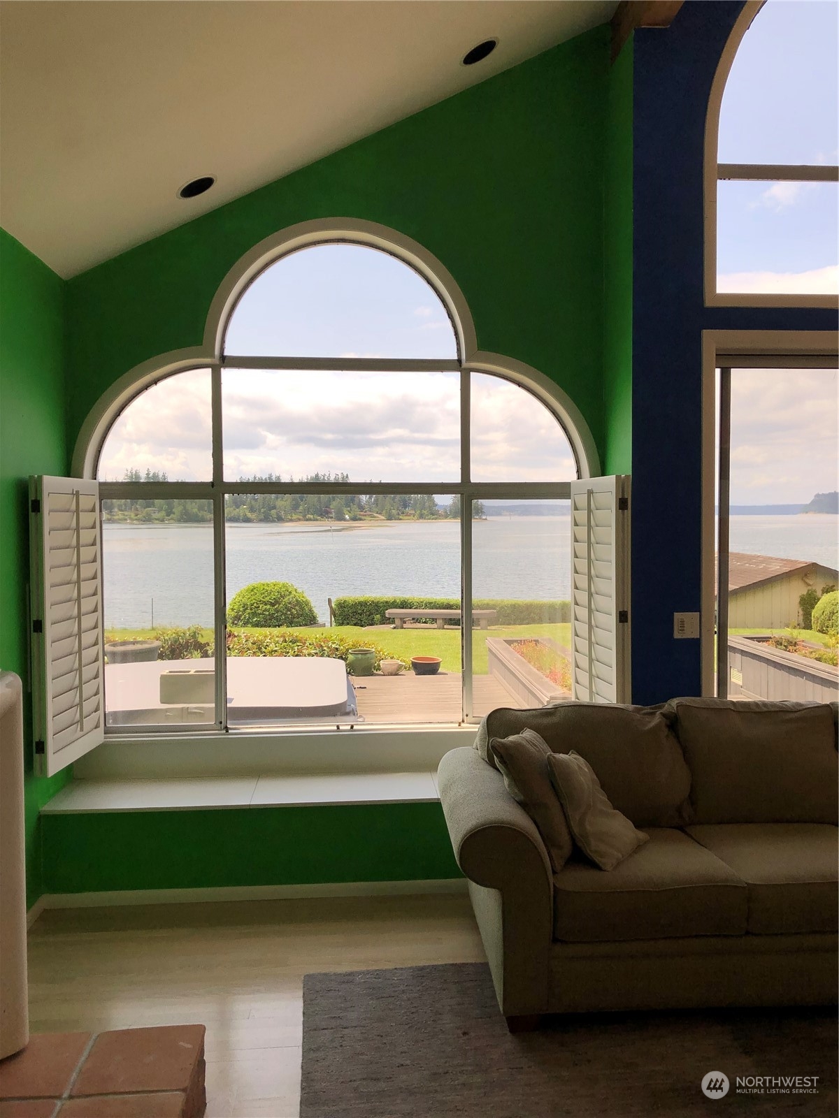 6918 Totem Beach Loop Road Marysville, WA 98271 - Photo 10 of 29 a living room with a large window and a wooden floor