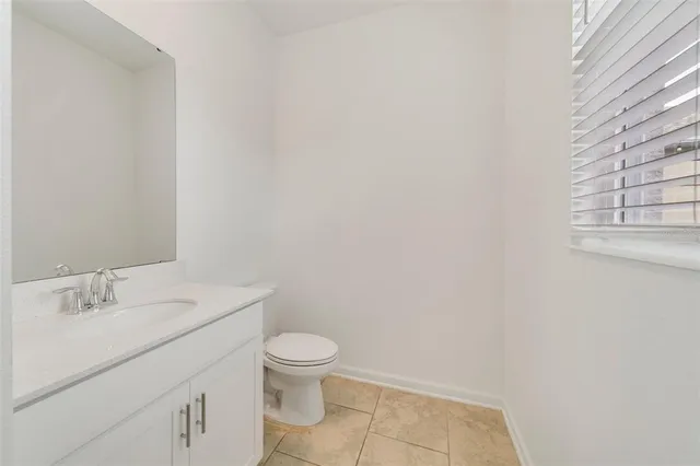 a bathroom with a white toilet and sink