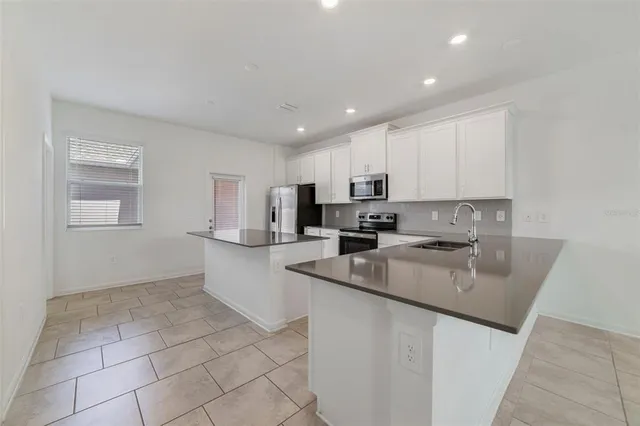 an empty room with white walls and stairs