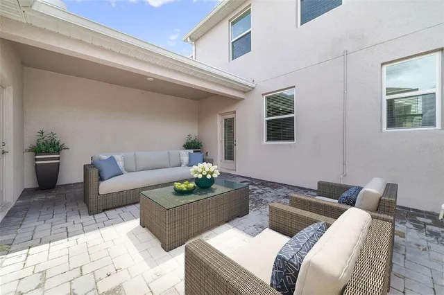 a living room with furniture and a potted plant