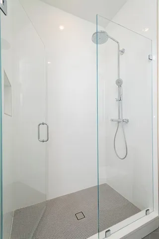 a bathroom with a glass shower door