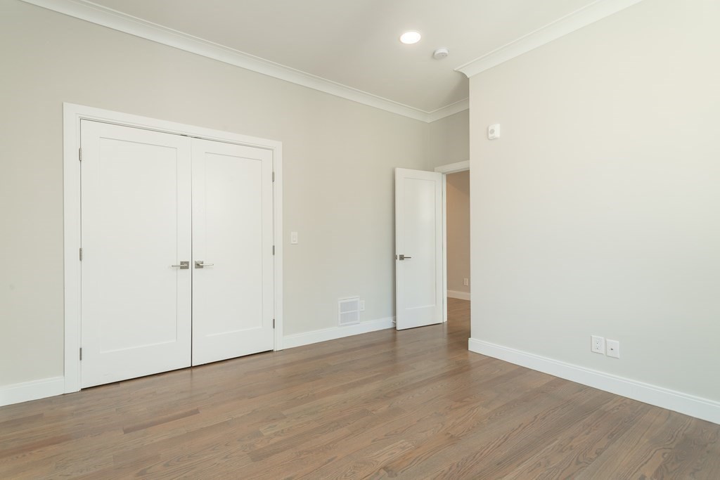 3247 Washington Street, Unit 3 Boston, MA 02130 - Photo 12 of 15 an empty room with wooden floor