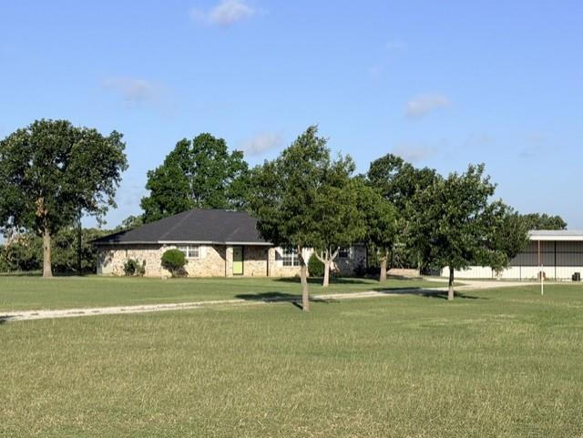 4316 Leona Road Bowie, TX 76230 - Photo 2 of 37 a garden with trees in the background
