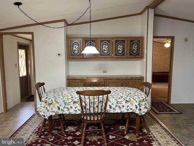 a outdoor dining area with a table and chairs