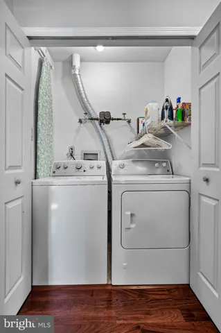 a utility room with closet dryer and washer