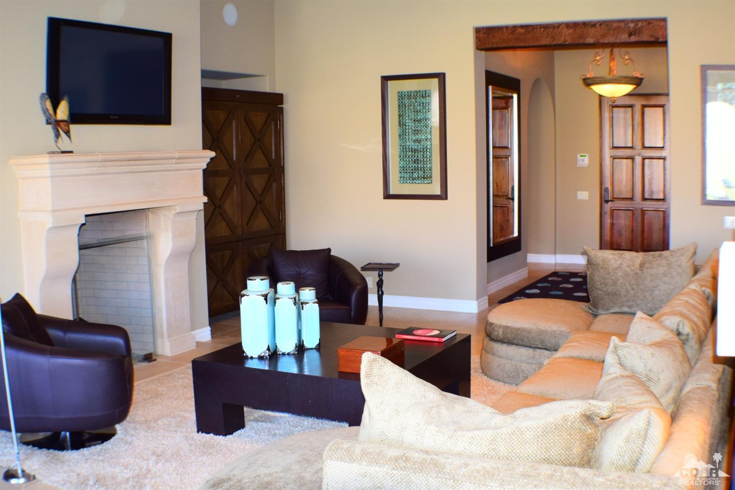 9 Santa Rosa Mountain Lane Rancho Mirage, CA 92270 - Photo 17 of 58 a bedroom with furniture and a fireplace