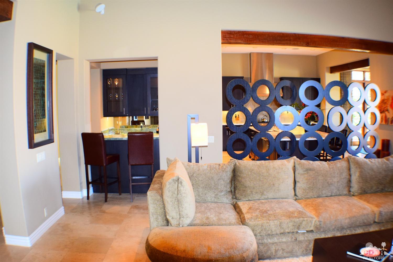 9 Santa Rosa Mountain Lane Rancho Mirage, CA 92270 - Photo 18 of 58 a living room with furniture and painting on the wall