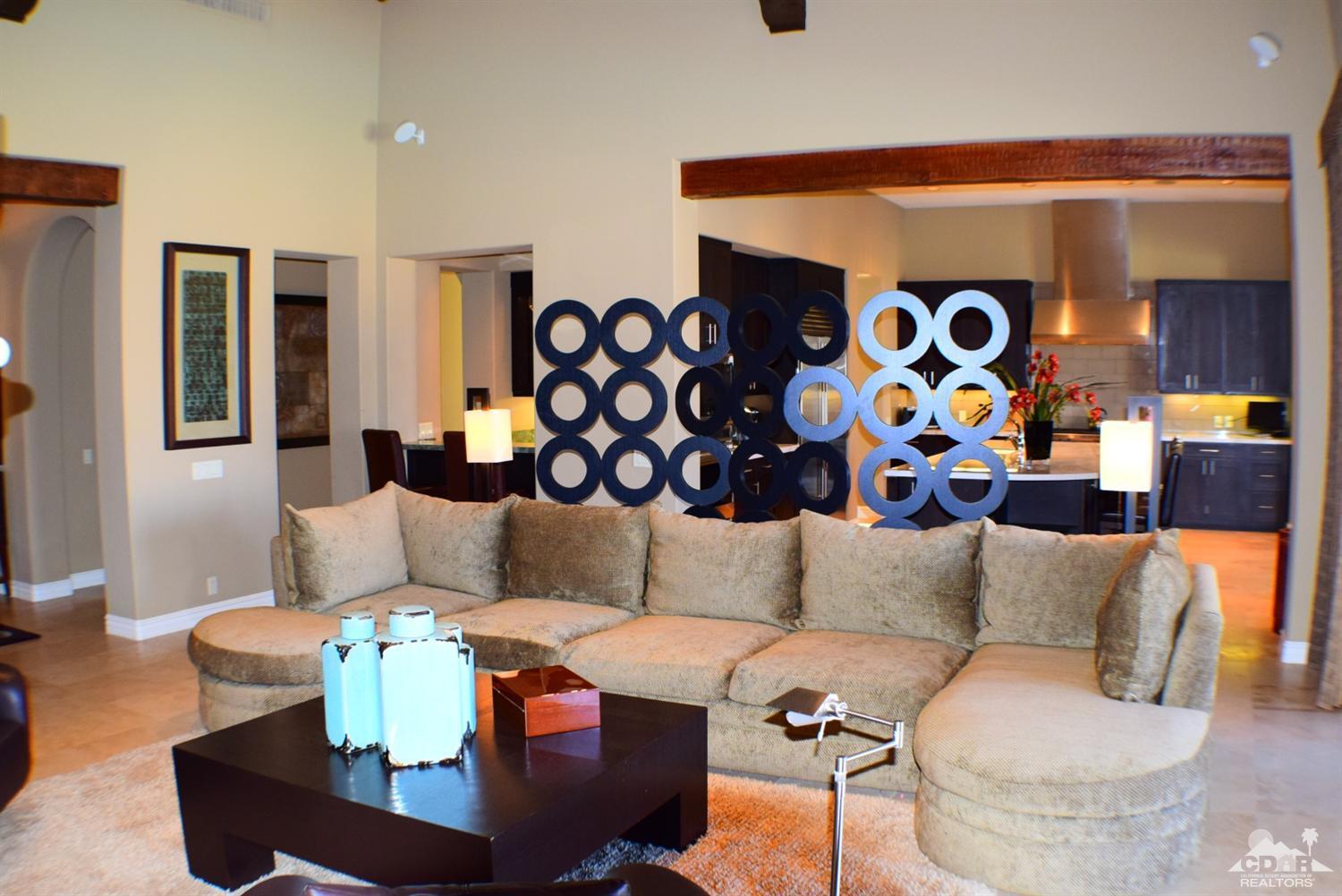9 Santa Rosa Mountain Lane Rancho Mirage, CA 92270 - Photo 19 of 58 a living room with furniture and a painting on the wall