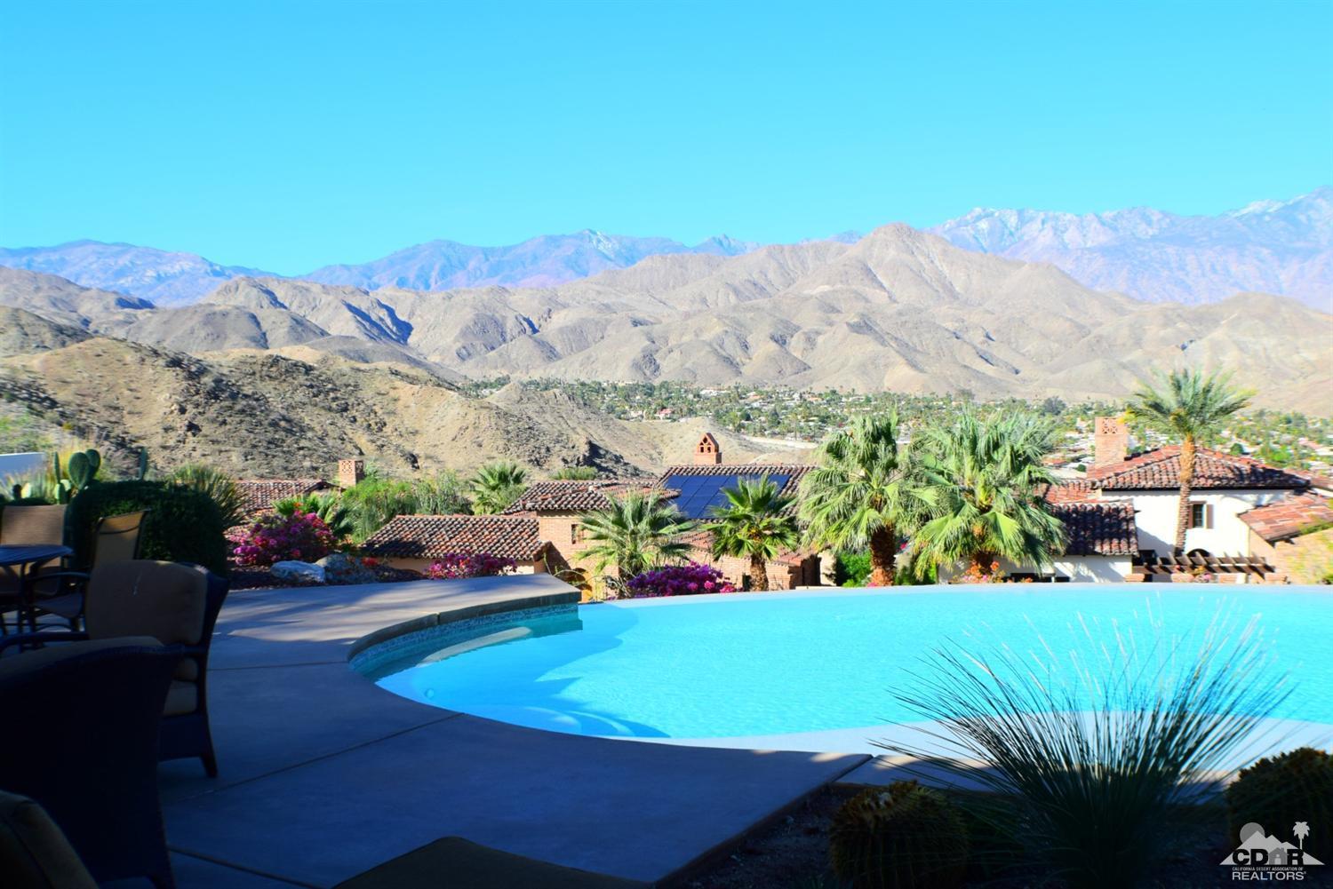9 Santa Rosa Mountain Lane Rancho Mirage, CA 92270 - Photo 3 of 58 a view of a swimming pool with a yard