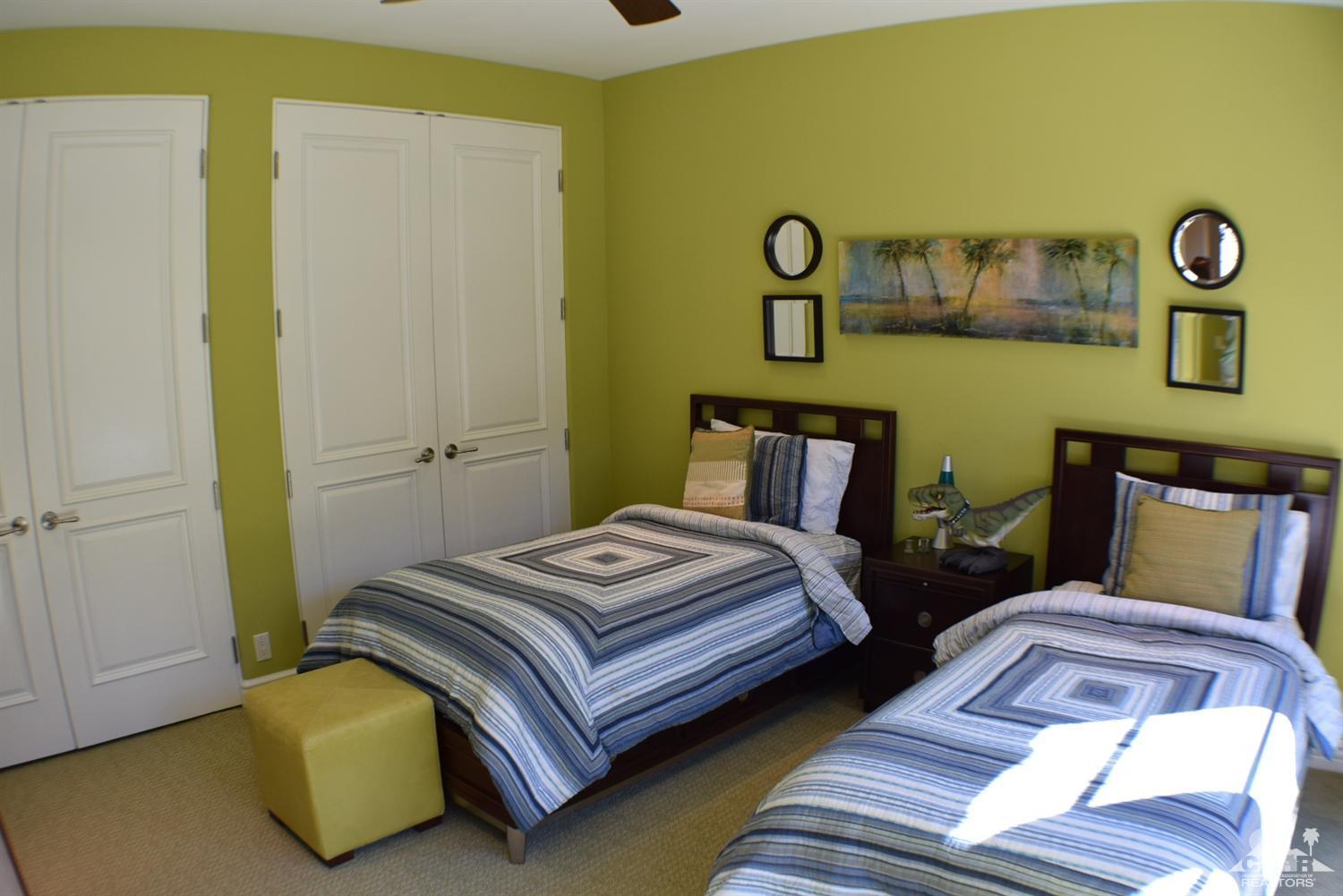 9 Santa Rosa Mountain Lane Rancho Mirage, CA 92270 - Photo 25 of 58 a bedroom with bed and a mirror