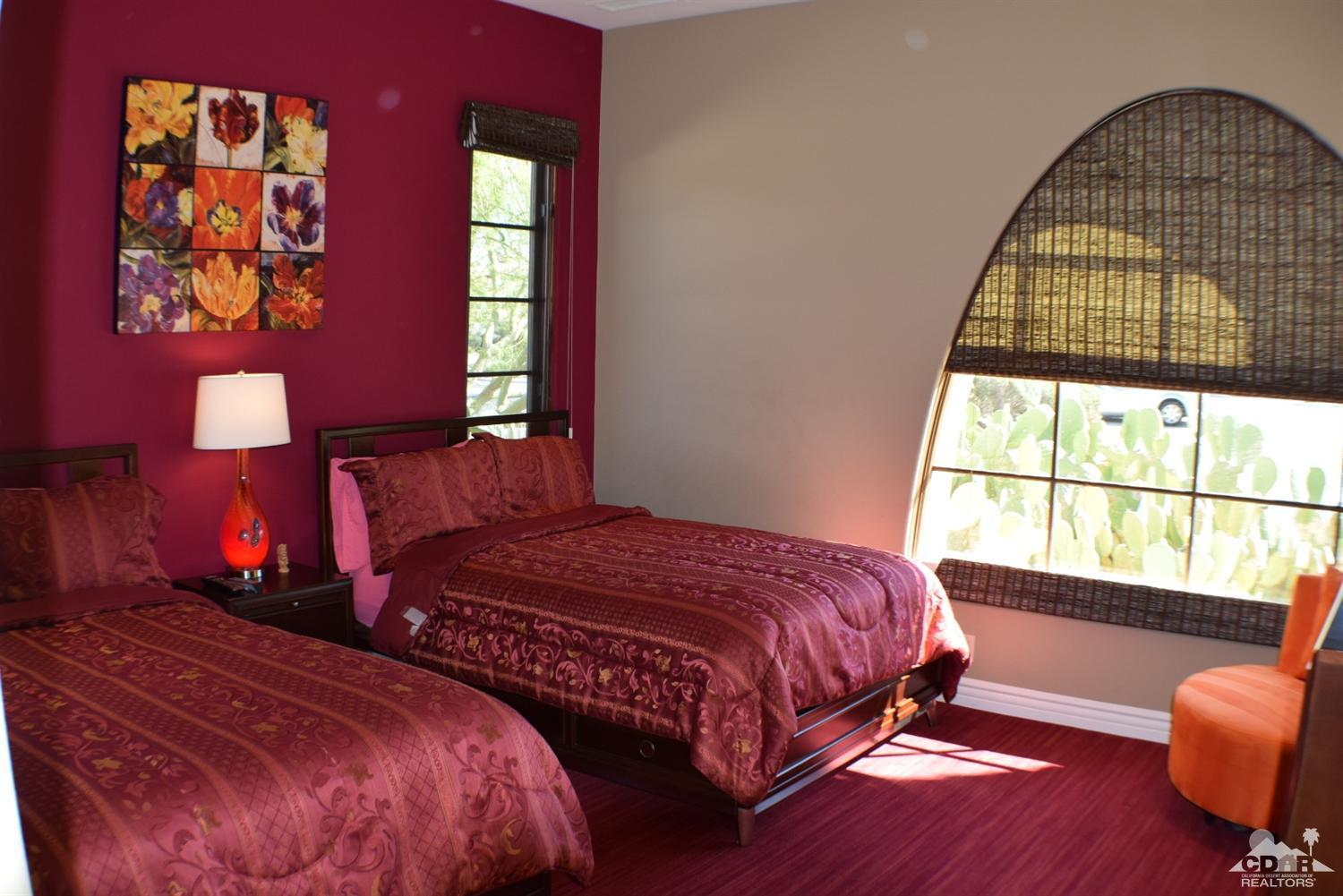 9 Santa Rosa Mountain Lane Rancho Mirage, CA 92270 - Photo 26 of 58 a bedroom with a bed and a lamp next to a window