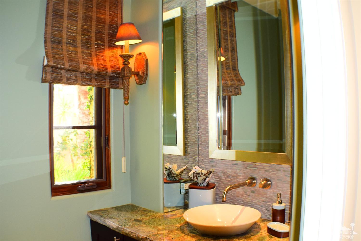 9 Santa Rosa Mountain Lane Rancho Mirage, CA 92270 - Photo 33 of 58 a bathroom with a granite countertop sink and a mirror