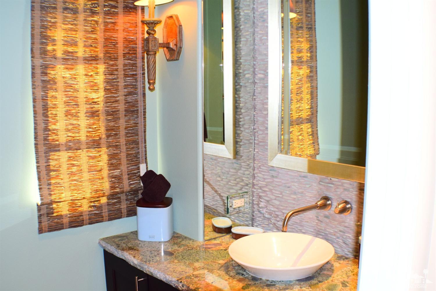 9 Santa Rosa Mountain Lane Rancho Mirage, CA 92270 - Photo 34 of 58 a bathroom with a granite countertop sink and a mirror