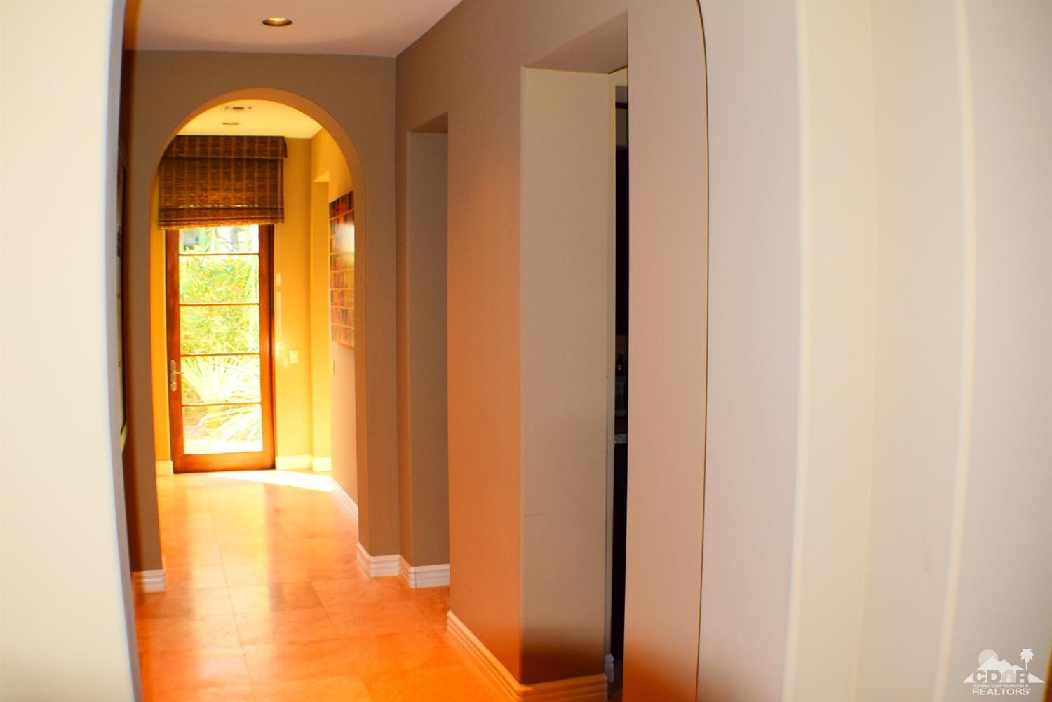 9 Santa Rosa Mountain Lane Rancho Mirage, CA 92270 - Photo 36 of 58 a view of a hallway with windows