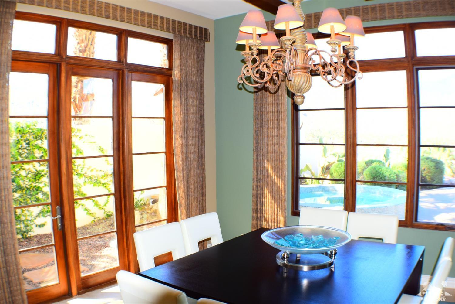 9 Santa Rosa Mountain Lane Rancho Mirage, CA 92270 - Photo 39 of 58 a view of a dining room with furniture a chandelier and wooden floor