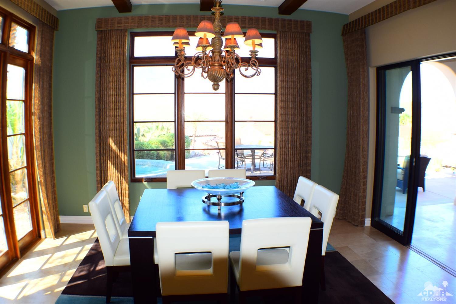 9 Santa Rosa Mountain Lane Rancho Mirage, CA 92270 - Photo 40 of 58 a view of a dining room with furniture a chandelier and wooden floor
