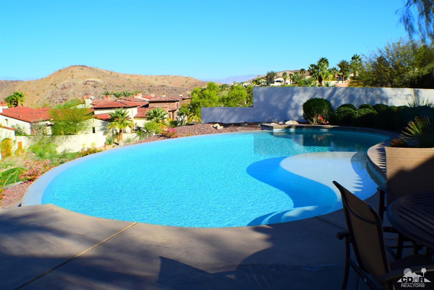 9 Santa Rosa Mountain Lane Rancho Mirage, CA 92270 - Photo 5 of 58 a view of a swimming pool with lounge chairs
