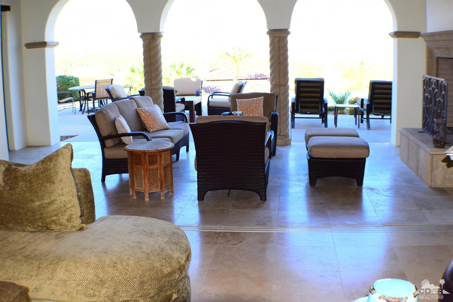 9 Santa Rosa Mountain Lane Rancho Mirage, CA 92270 - Photo 42 of 58 a living room with couches and a coffee table with garden view