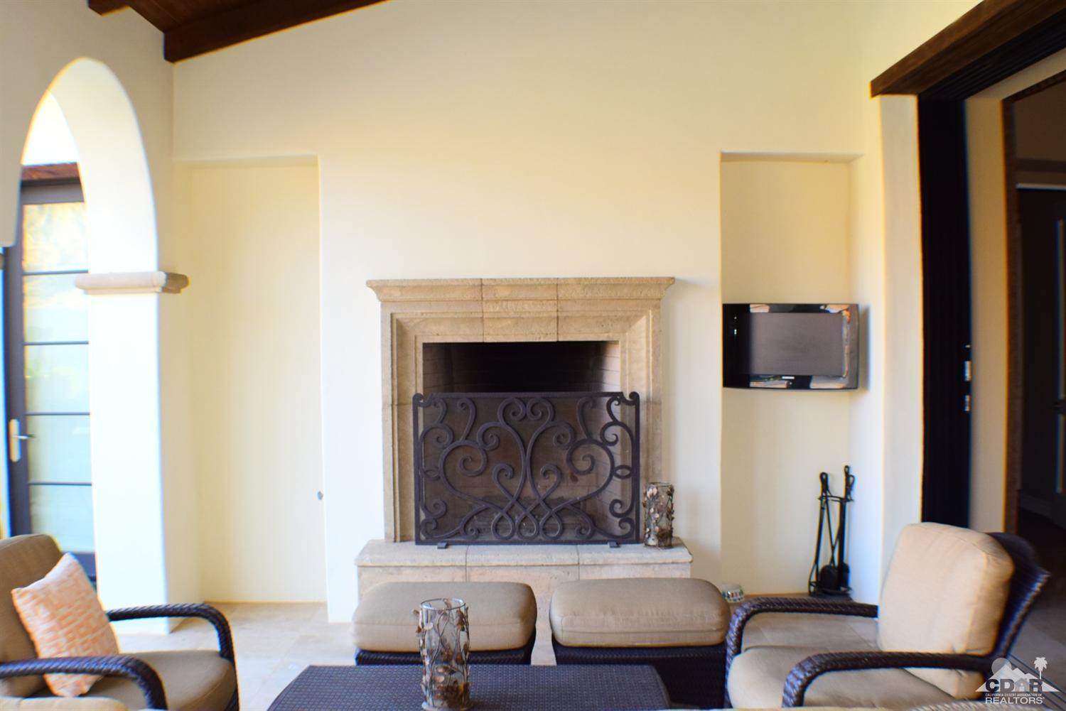 9 Santa Rosa Mountain Lane Rancho Mirage, CA 92270 - Photo 45 of 58 a living room with furniture and a fireplace