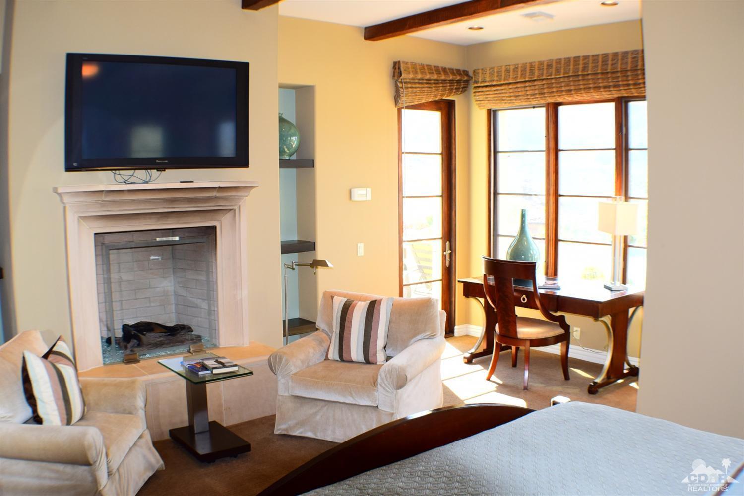 9 Santa Rosa Mountain Lane Rancho Mirage, CA 92270 - Photo 52 of 58 a living room with furniture a flat screen tv and a floor to ceiling window