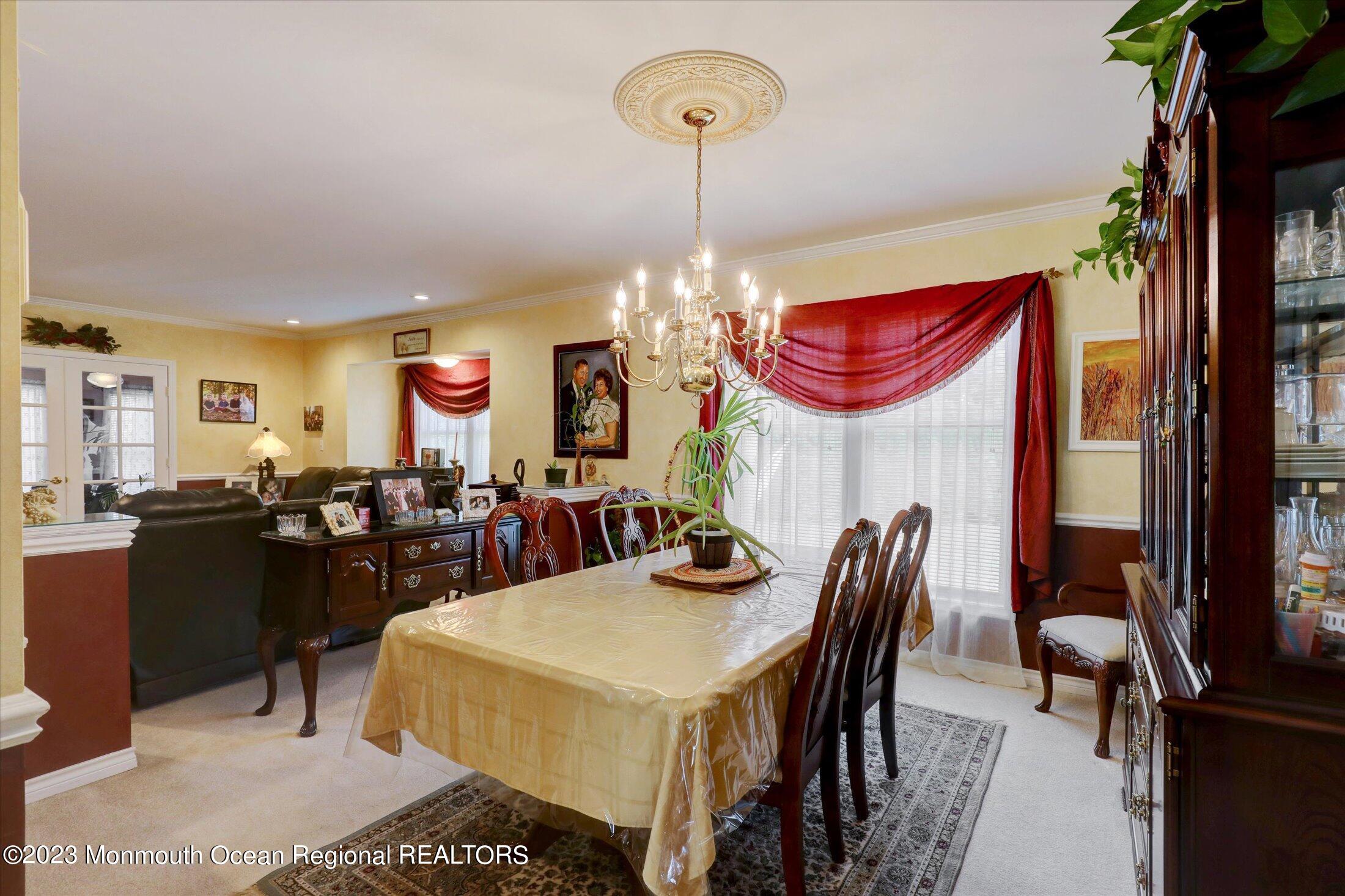 847 Waterworks Road Freehold, NJ 07728 - Photo 14 of 74 a view of a dining room with furniture and chandelier