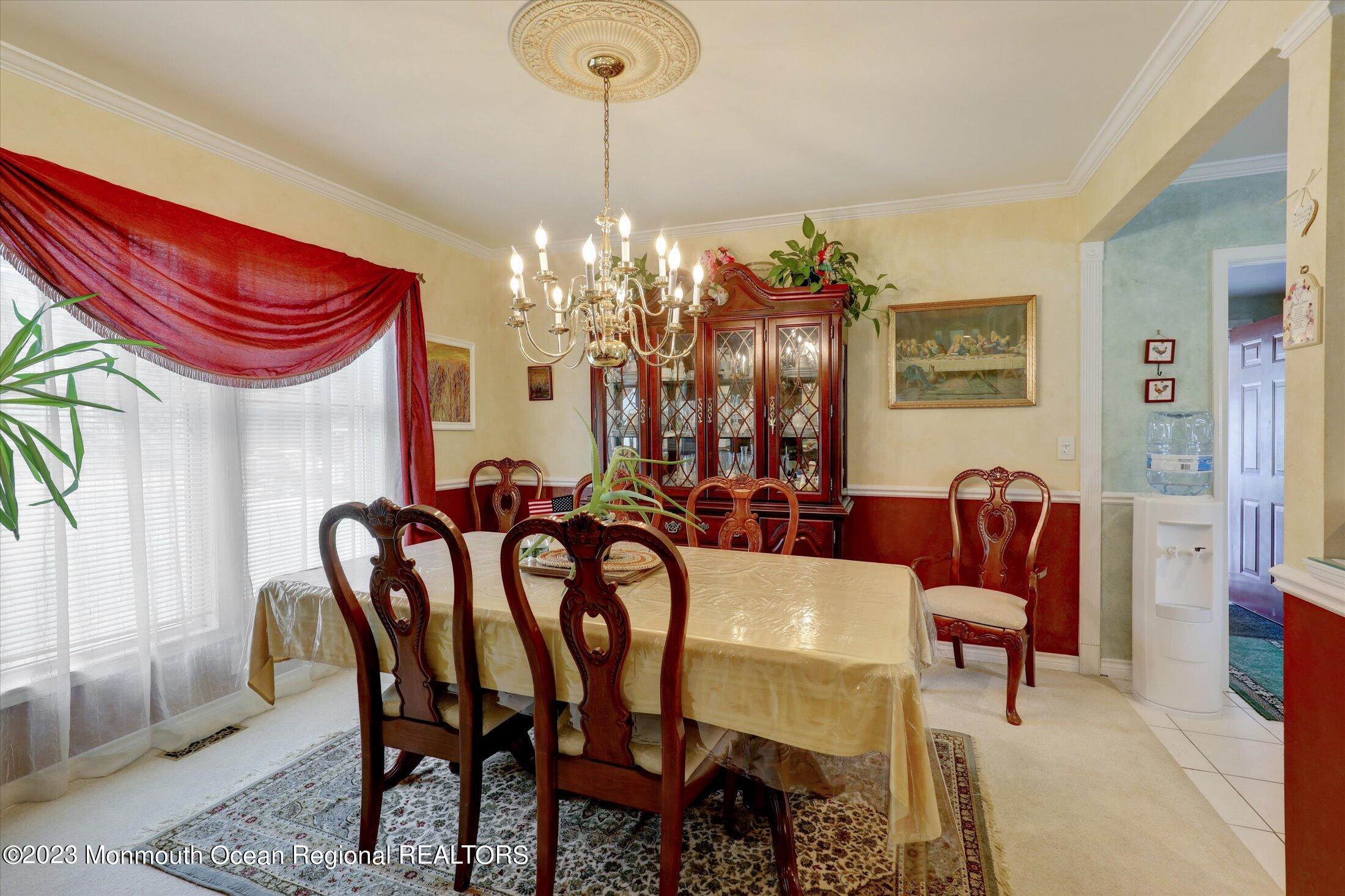 847 Waterworks Road Freehold, NJ 07728 - Photo 15 of 74 a view of a dining room with furniture and chandelier
