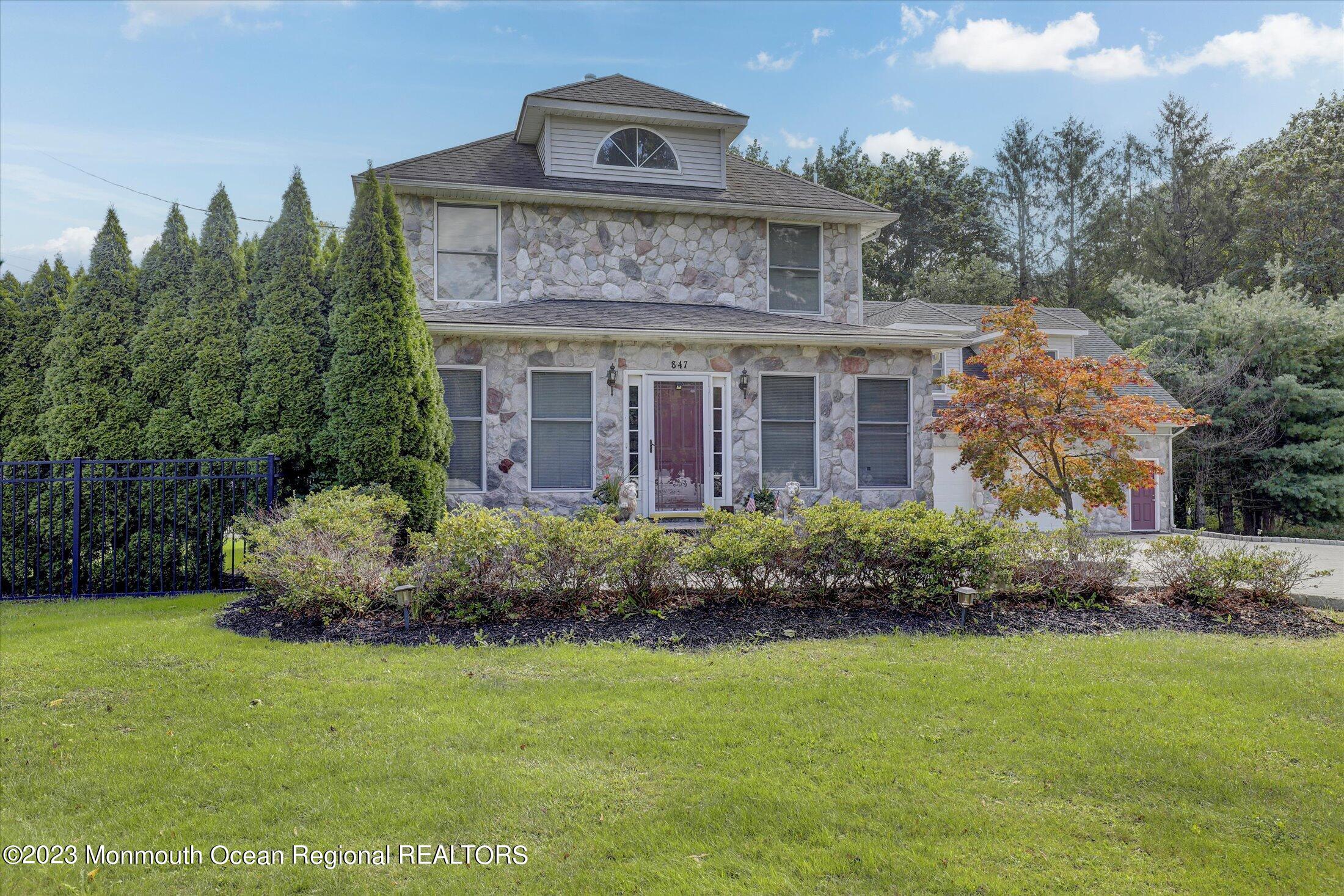 847 Waterworks Road Freehold, NJ 07728 - Photo 2 of 74 a front view of a house with a garden