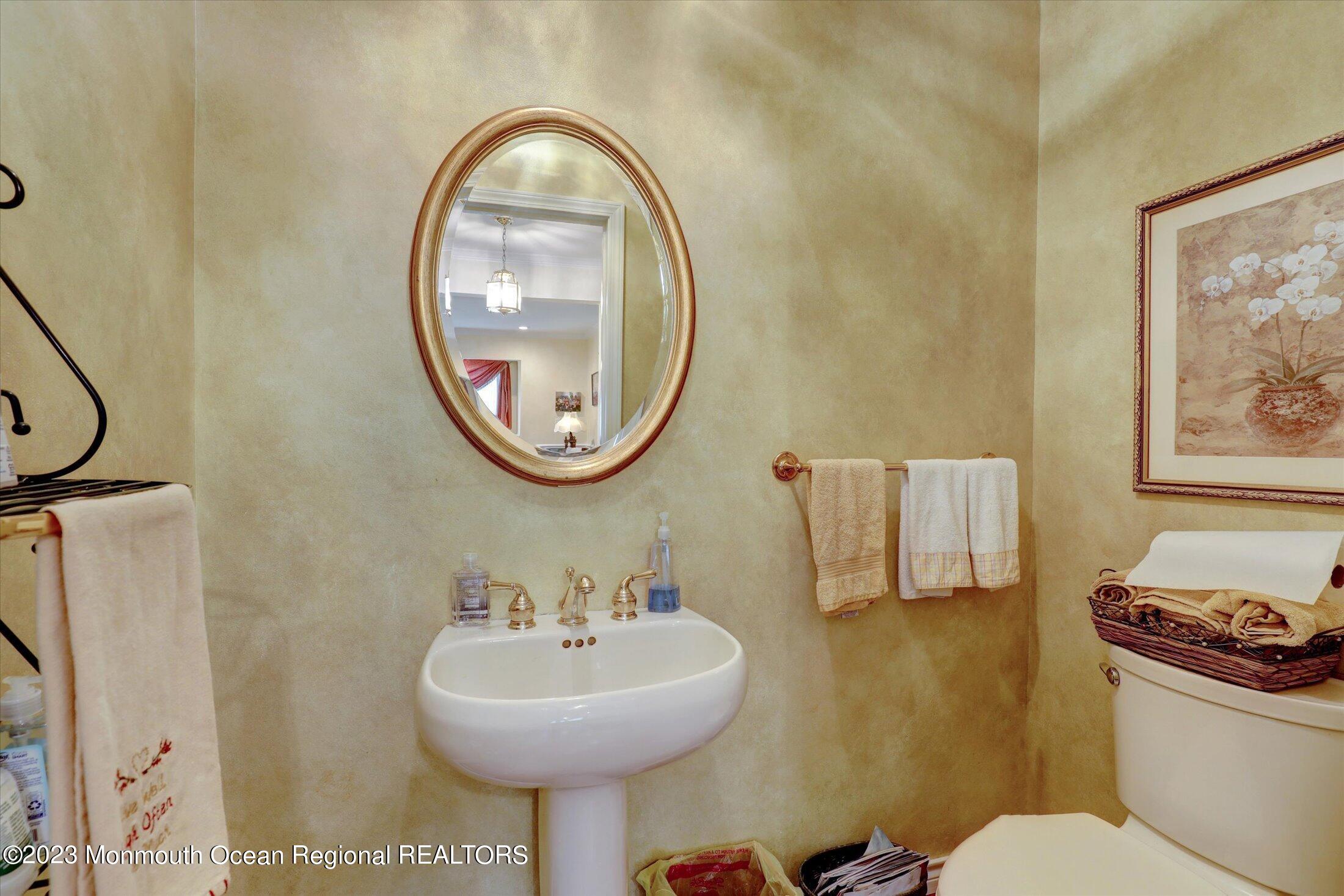 847 Waterworks Road Freehold, NJ 07728 - Photo 21 of 74 a bathroom with a sink a mirror and a toilet