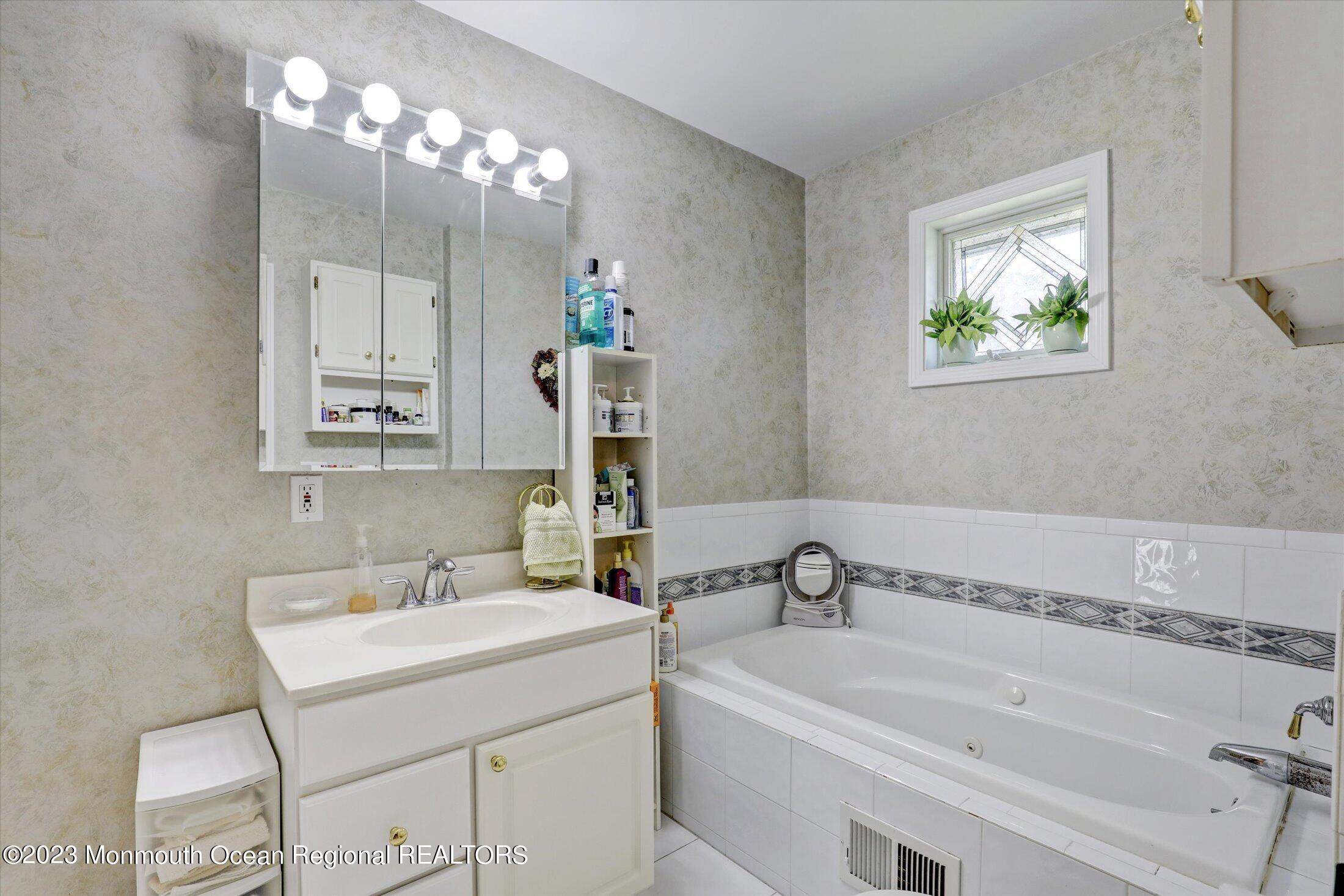 847 Waterworks Road Freehold, NJ 07728 - Photo 29 of 74 a bathroom with a sink and a bathtub