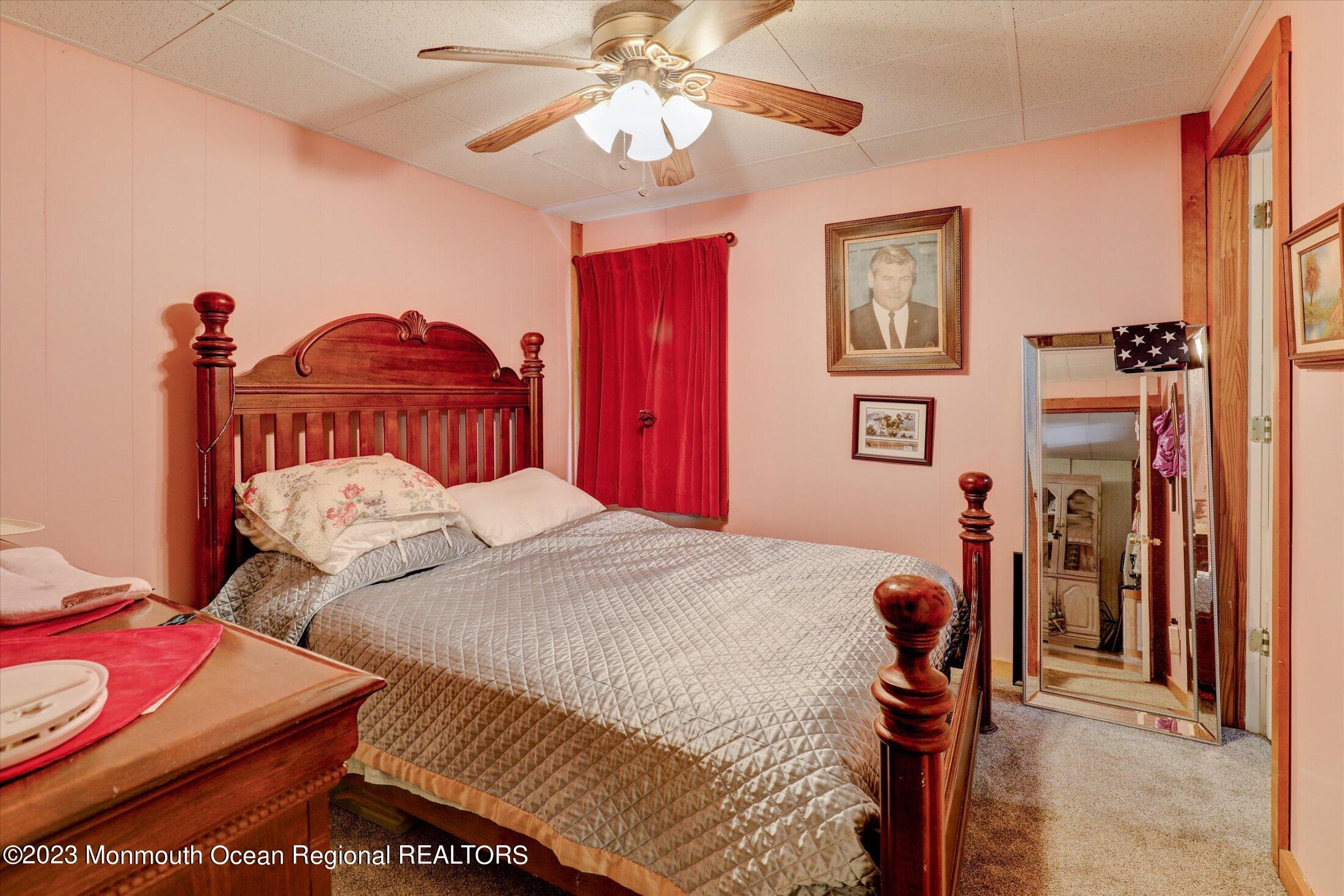 847 Waterworks Road Freehold, NJ 07728 - Photo 48 of 74 a bedroom with a bed and a chandelier