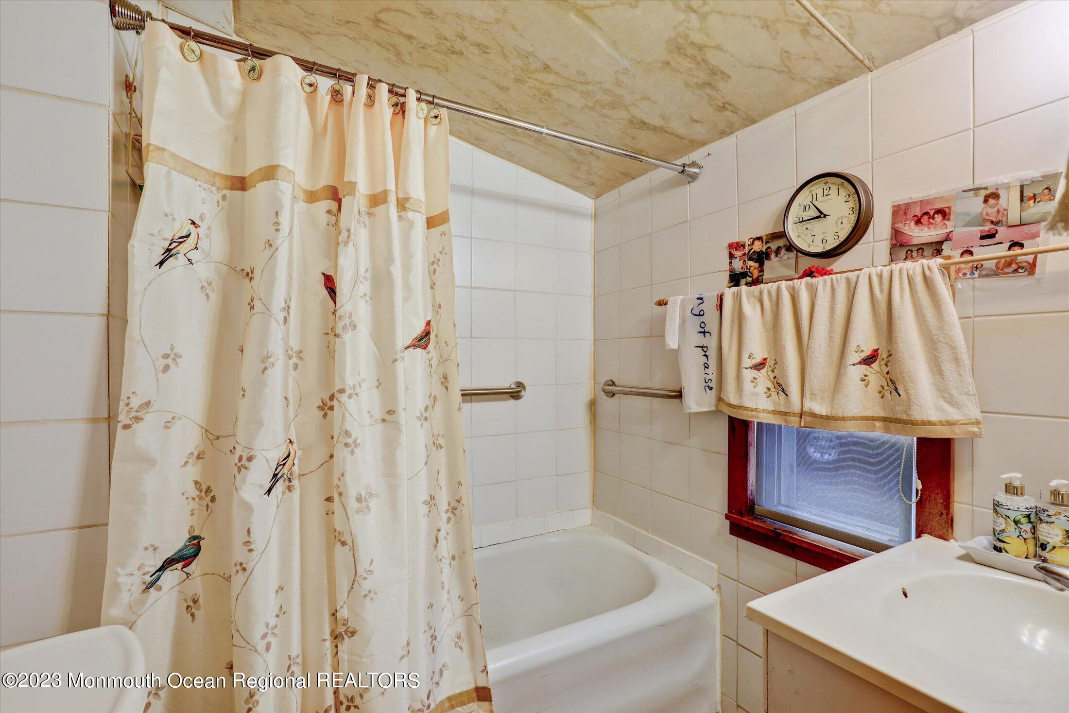 847 Waterworks Road Freehold, NJ 07728 - Photo 49 of 74 a bathroom with a bathtub and a shower