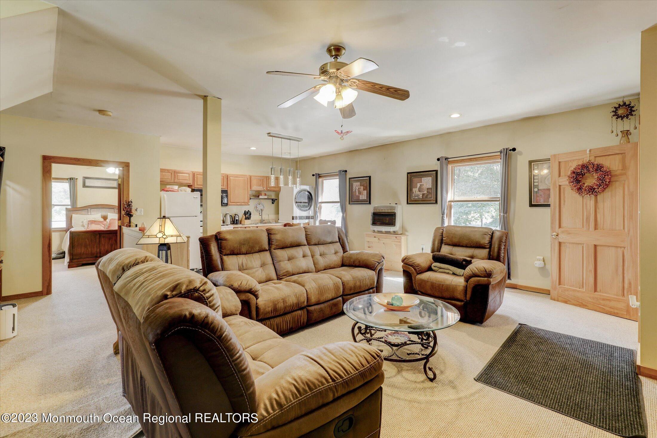 847 Waterworks Road Freehold, NJ 07728 - Photo 53 of 74 a living room with furniture ceiling fan and a rug
