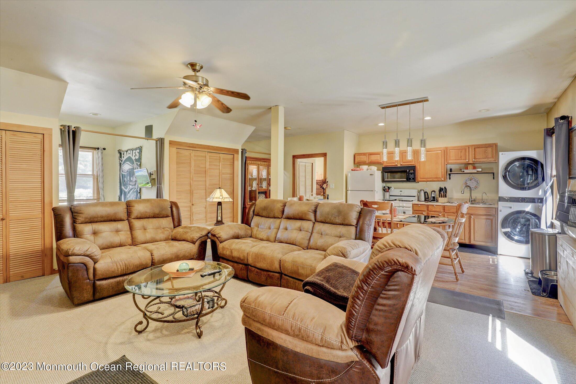 847 Waterworks Road Freehold, NJ 07728 - Photo 54 of 74 a living room with furniture kitchen view and a chandelier