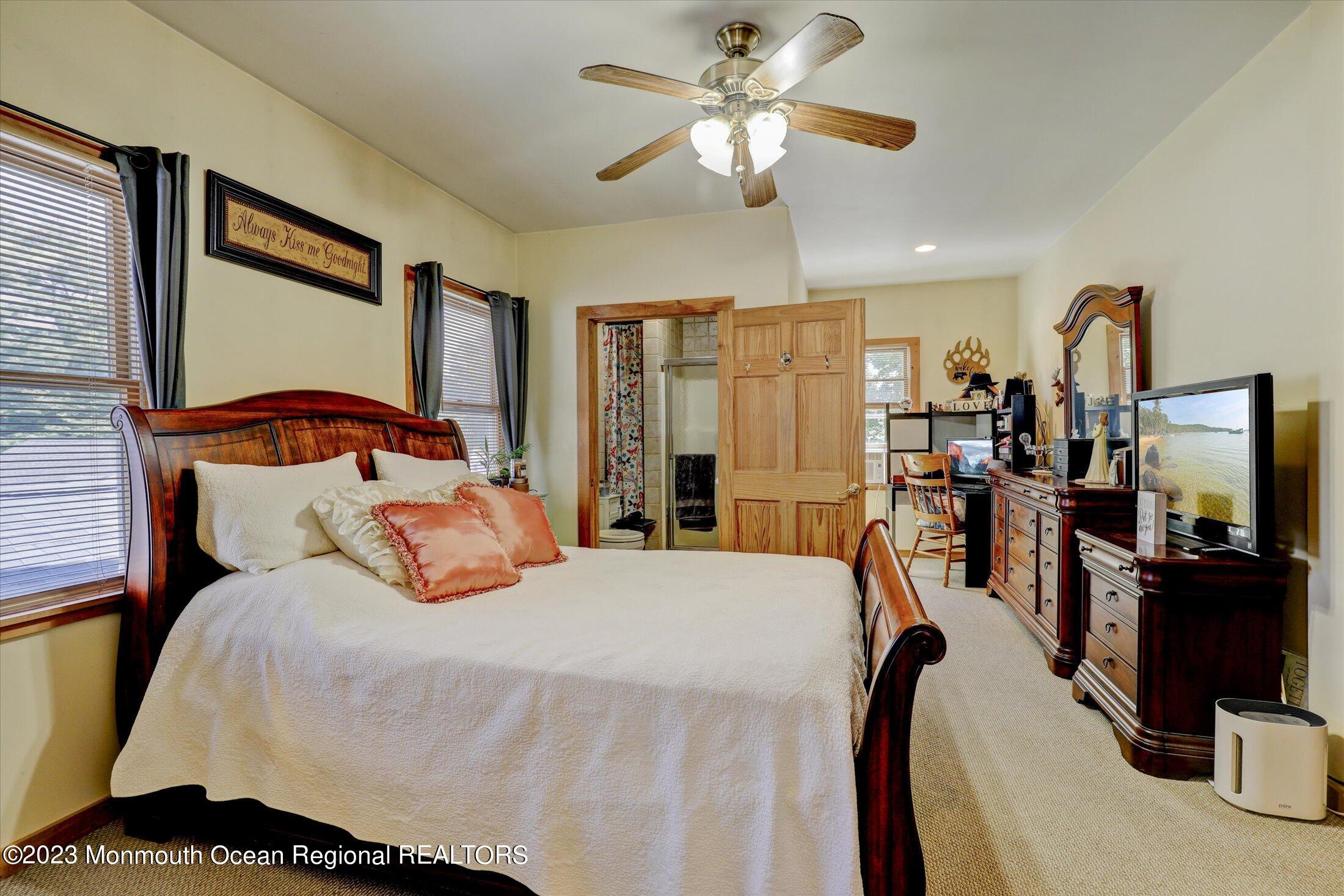 847 Waterworks Road Freehold, NJ 07728 - Photo 57 of 74 a bedroom with a bed a flat screen tv and a chandelier