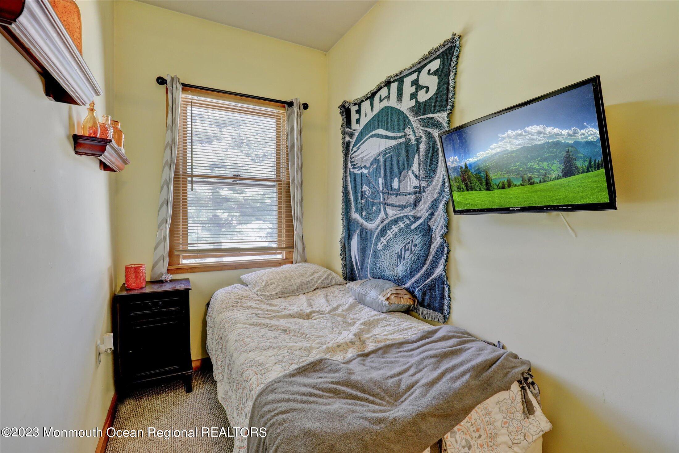 847 Waterworks Road Freehold, NJ 07728 - Photo 59 of 74 a bedroom with a bed and a flat screen tv