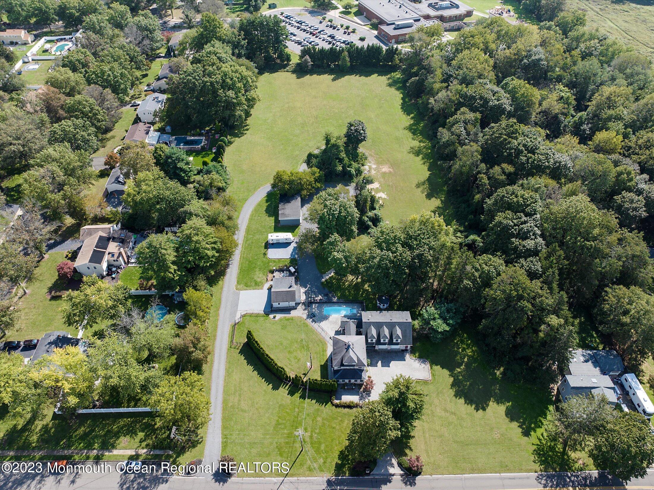 847 Waterworks Road Freehold, NJ 07728 - Photo 64 of 74 an aerial view of house with yard swimming pool and outdoor seating