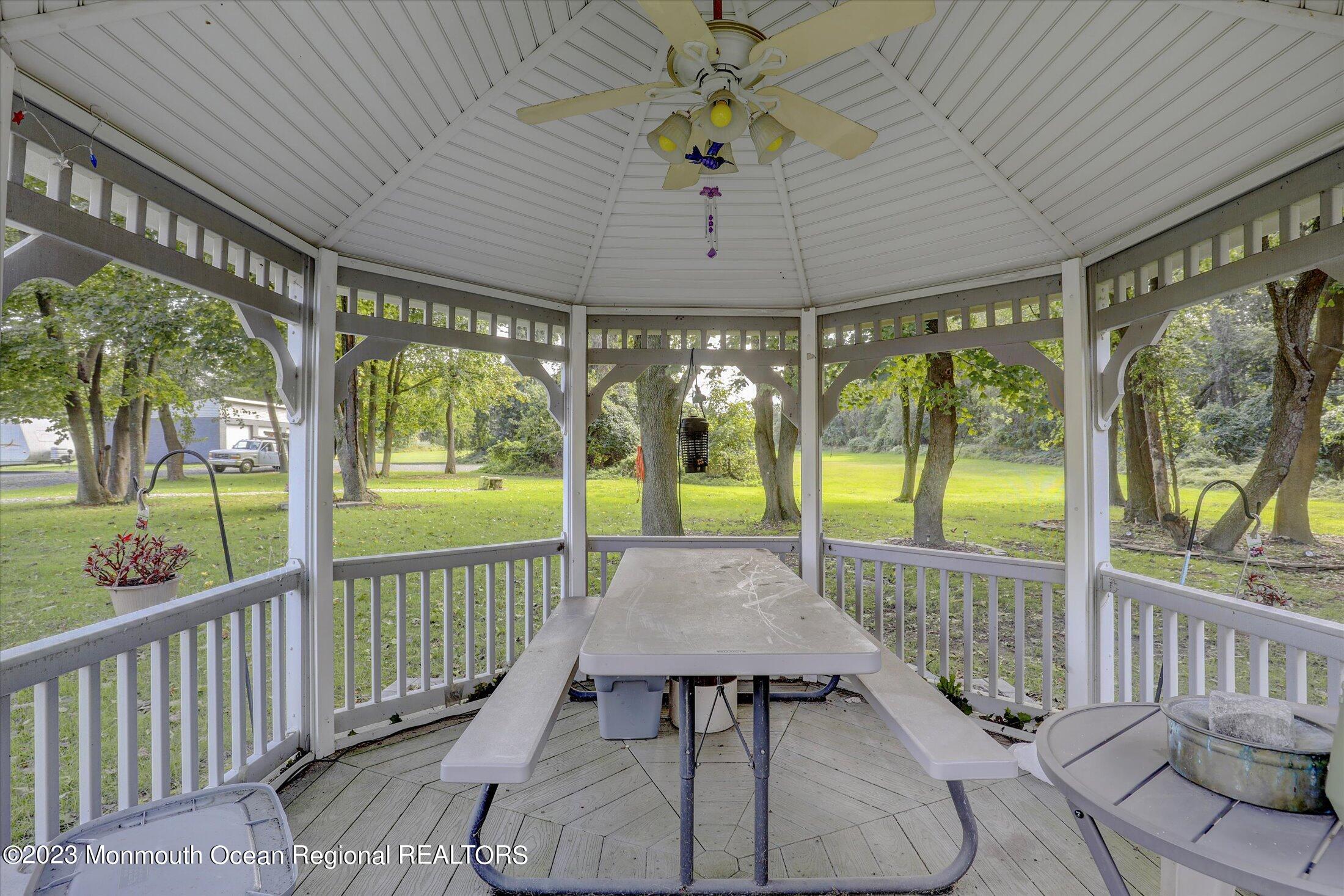 847 Waterworks Road Freehold, NJ 07728 - Photo 73 of 74 a view of a patio with a table chairs and a patio