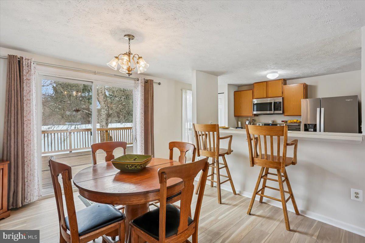 18112 Kodella Court Gaithersburg, MD 20877 - Photo 15 of 60 a view of a dining room with furniture window and outside view