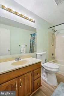 an empty room with a painting on the wall