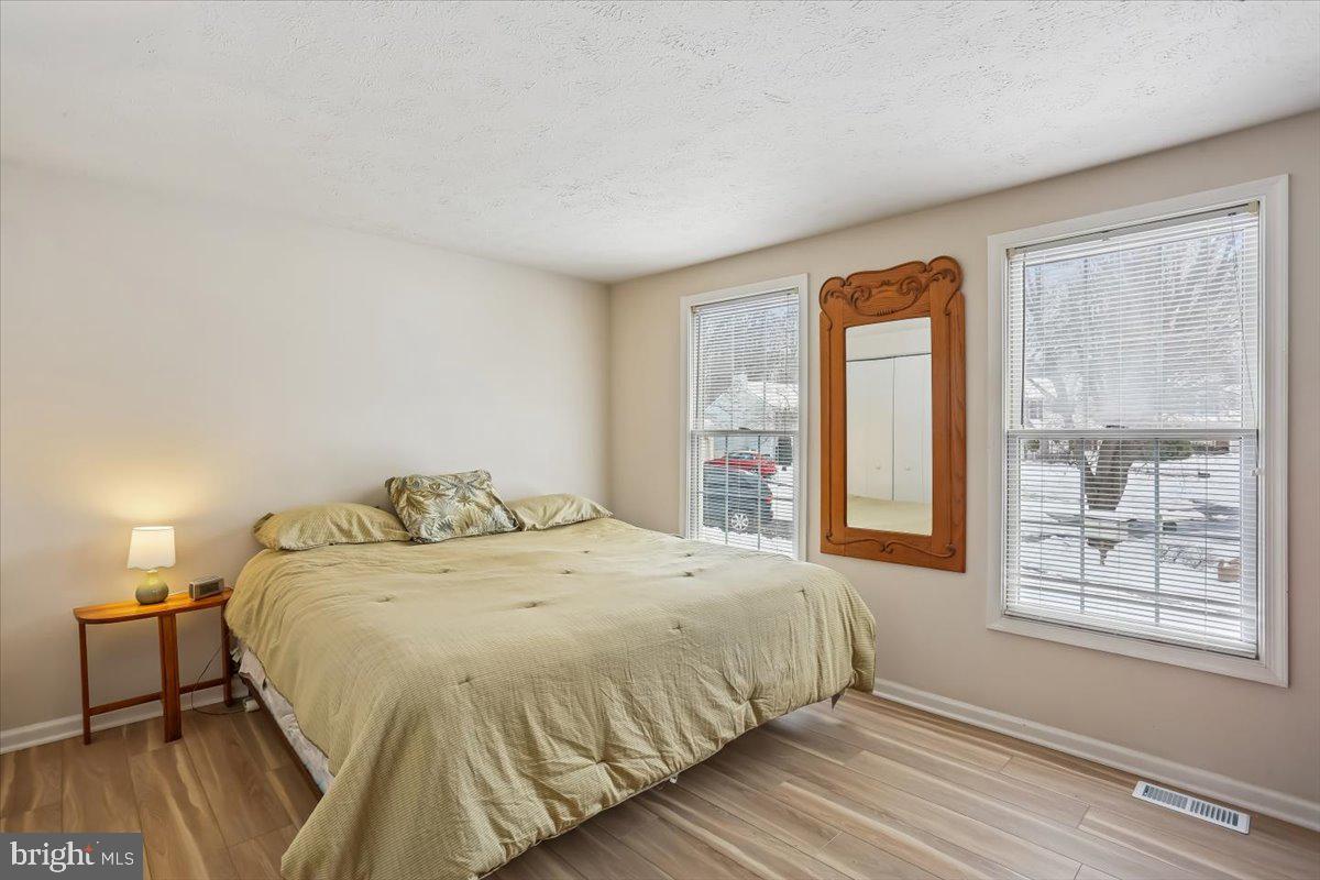18112 Kodella Court Gaithersburg, MD 20877 - Photo 24 of 60 a spacious bedroom with a bed and wooden floor