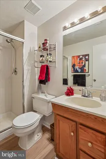 a view of backyard with wooden deck and large trees