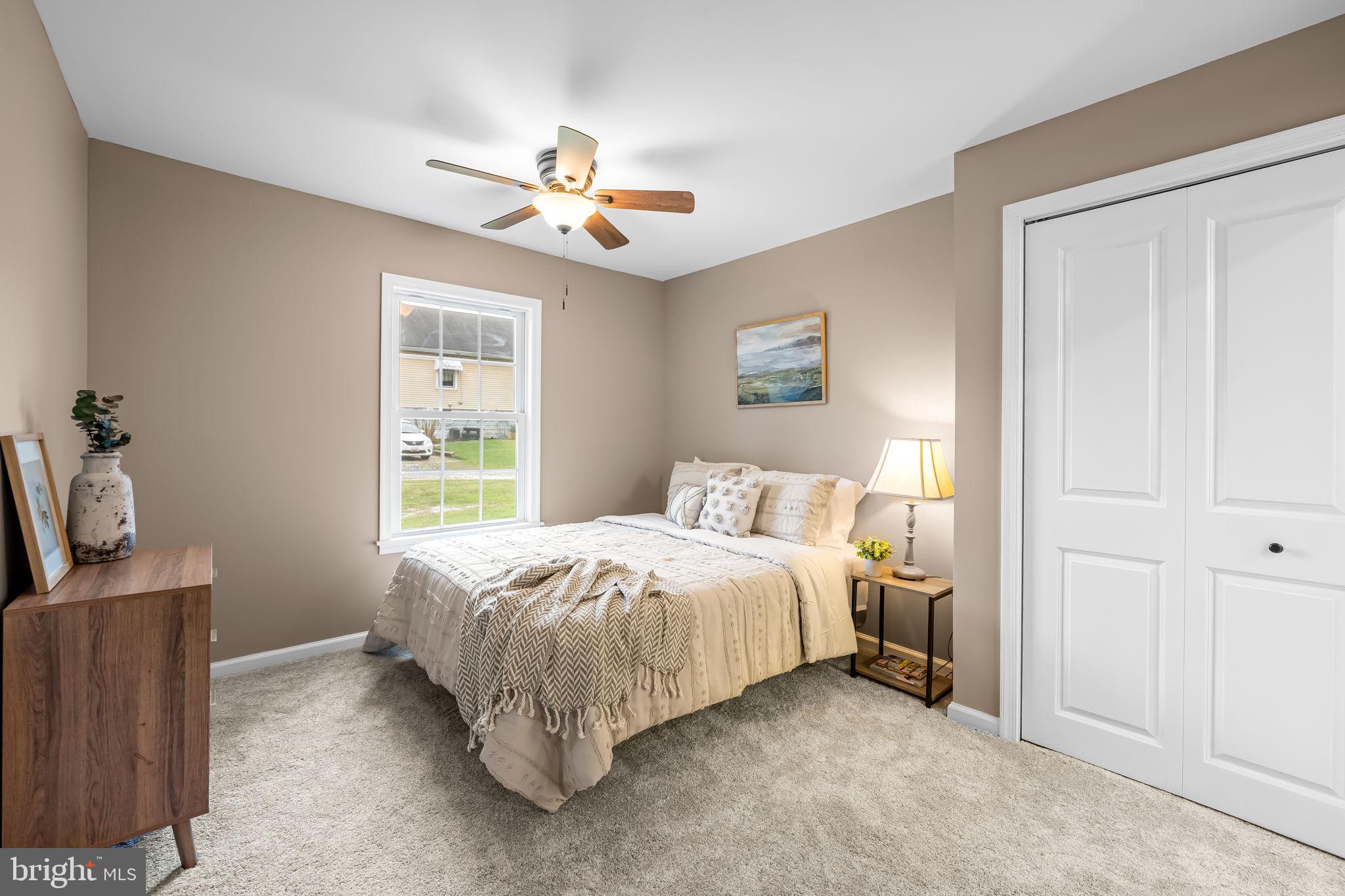 628 North Stuart Street Baltimore, MD 21221 - Photo 16 of 39 a bedroom with a bed and a chandelier