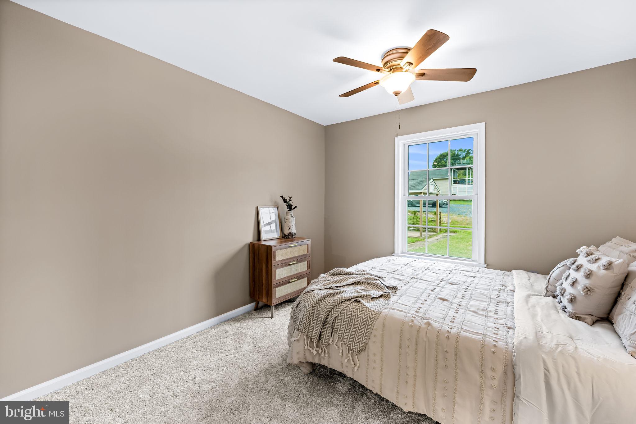 628 North Stuart Street Baltimore, MD 21221 - Photo 17 of 39 a bedroom with a bed and a ceiling fan