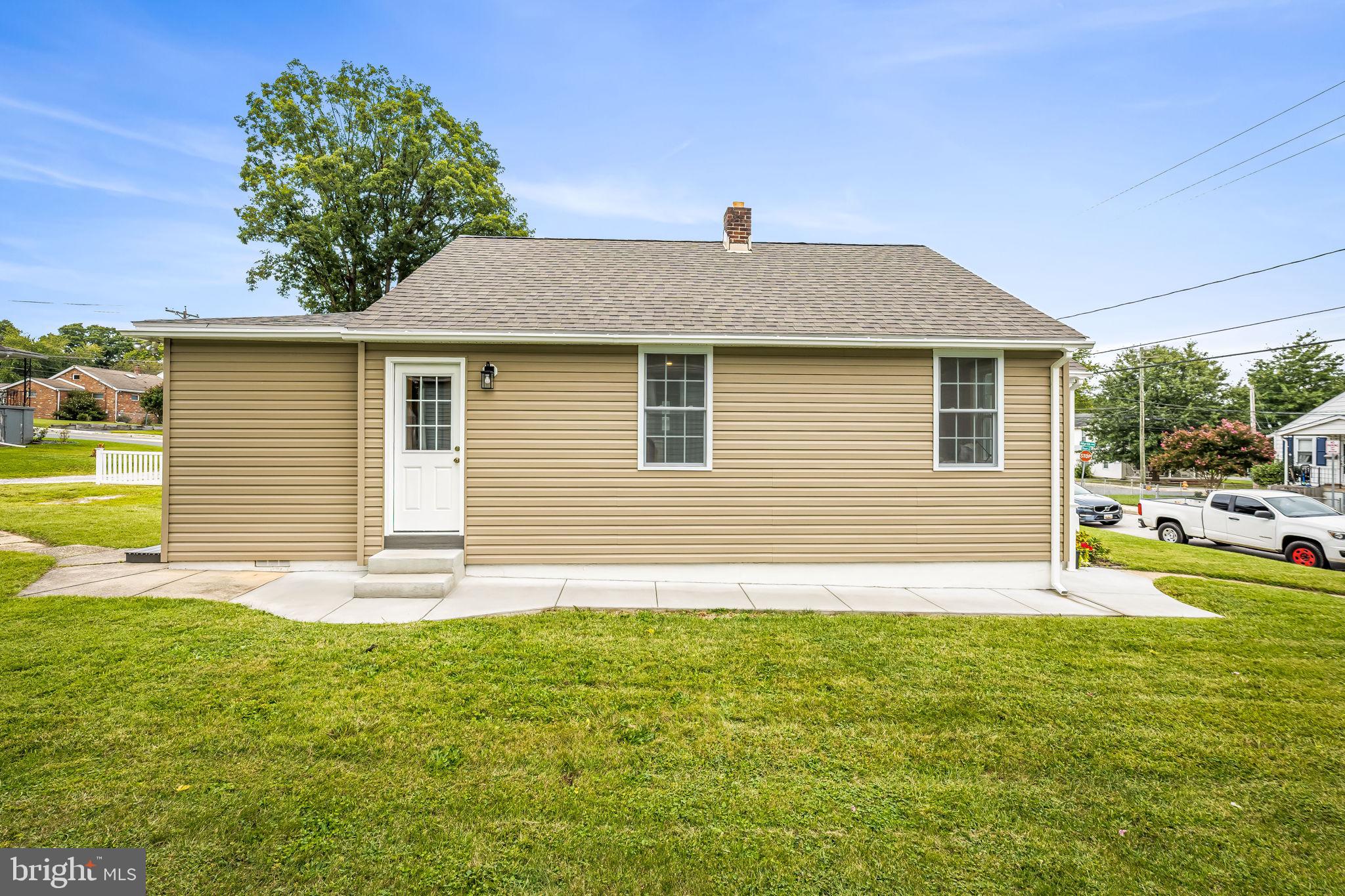 628 North Stuart Street Baltimore, MD 21221 - Photo 30 of 39 a front view of a house with a yard and trees